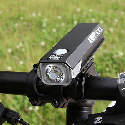 Cyclist using the CATEYE AMPP 500 light in nighttime conditions.