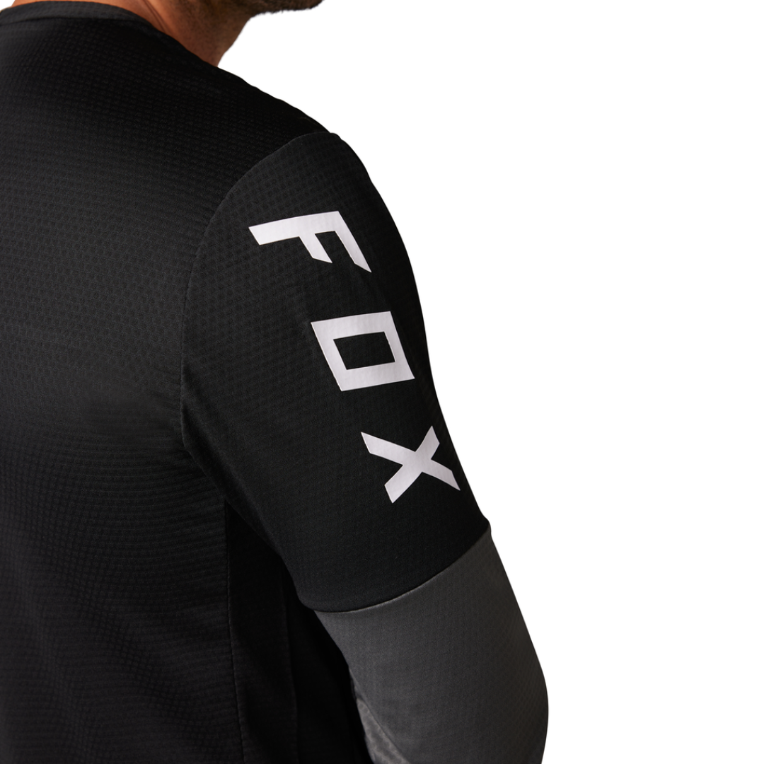 FOX Defend LS Jersey showcasing abrasion-resistant panels on rugged terrain.